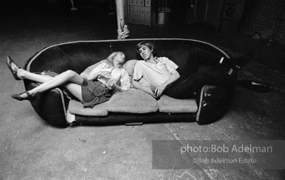 Bibbe Hanson and Chuck Wein on the infamous red couch at Warhol's Factory. New York City, 1965.