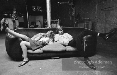 Bibbe Hanson and Chuck Wein on the infamous red couch at Warhol's Factory. New York City, 1965.