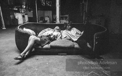 Bibbe Hanson and Chuck Wein on the infamous red couch at Warhol's Factory. New York City, 1965.