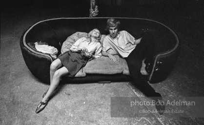 Bibbe Hanson and Chuck Wein on the infamous red couch at Warhol's Factory. New York City, 1965.