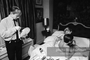 Andy Warhol seals a film canister during the filming of Beauty #2. New York City apartment, 1965.