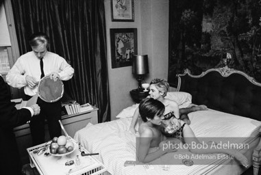 Andy Warhol seals a film canister during the filming of Beauty #2. New York City apartment, 1965.