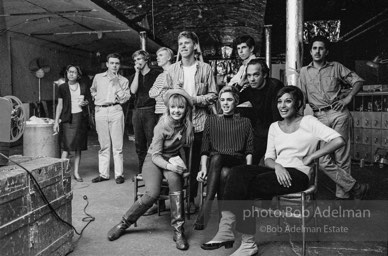 Film screening at the Factory. Standing, left to right: Unknown, Unknown, Chuck Wein, Andy Warhol, Unknown, Stephen Shore, Unknown, Unknown. Sitting, left to right: Bibbe Hansen, Edie
Sedgwick, Pat Hartley. The Factory, 1965.