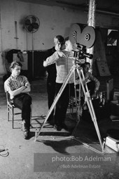 left to right: Gerard Melanga (seated) , Chuck Wein, Andy Warhol and Buddy
Wirtschafter during the filming
of Prison (aka Girls In Prison). The Factory, 1965.