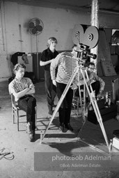 left to right: Gerard Melanga (seated) , Chuck Wein, Andy Warhol and Buddy
Wirtschafter during the filming
of Prison (aka Girls In Prison). The Factory, 1965.