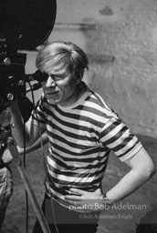 Andy Warhol behind the camera during the filming of 