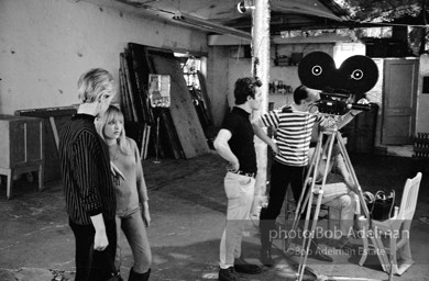 Left to right: Edie Sedgwick,Bibbe Hansen, Gerard Malanga,Andy Warhol and BuddyWirtschafter during the filmingof Prison (aka Girls In Prison). The Factory, 1965.
