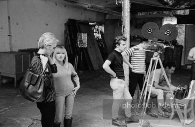 Left to right: Edie Sedgwick,Bibbe Hansen, Gerard Malanga,Andy Warhol and BuddyWirtschafter during the filmingof Prison (aka Girls In Prison). The Factory, 1965.
