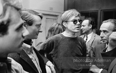 Gerard Melanga, Roy Lichtenstein, Andy Warhol, Leo Castelli- Ivan Karp in back. Party at Rauschenberg's studio/loft. New York City, 1965.