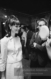 Andy Warhol fanning a party guest with a paper plate. The Factory. New York City, 1965.