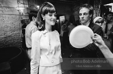 Andy Warhol fanning a party guest with a paper plate. The Factory. New York City, 1965.