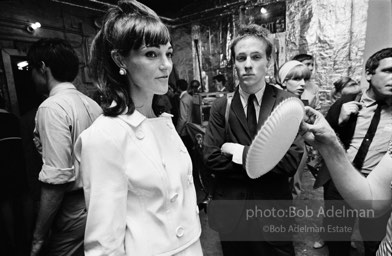 Andy Warhol fanning a party guest with a paper plate. The Factory. New York City, 1965.