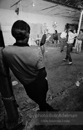 Edie Sedgwick dances as the first guets arrive at a perty at the Factory. 1965.