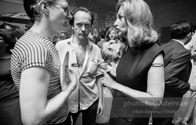 Andy with Edith Skull (art collector) talk at a Factory party for John Rublowsky and Ken Heyman’s book Pop Art..1965.