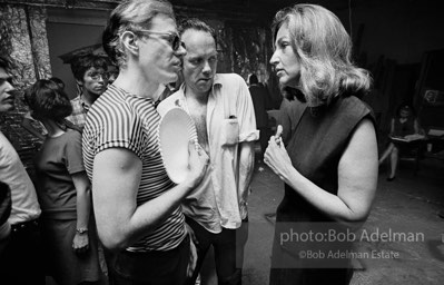 Andy with Edith Skull (art collector) talk at a Factory party for John Rublowsky and Ken Heyman’s book Pop Art..1965.