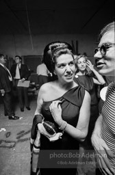 Party guest talks with Andy Warhol at a Factory party. 1965.