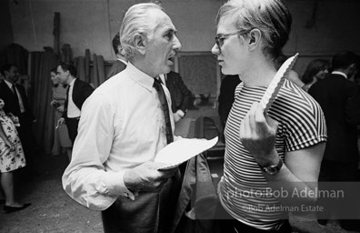 Party guest talks with Andy Warhol at a Factory party. 1965.