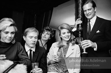 Edie Sedgwick and Andy Warhol with unidentified guest at a society party. New York City, 1965.