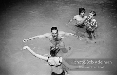 Edie Sedgwick, Kevin McCarthy, Chuck Wein and Andy Warhol in the pool at Al Roon's gym. New York City, 1965.