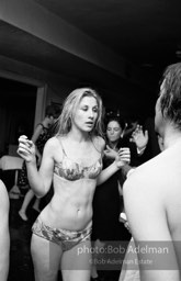 Warhol Superstar Baby Jane Holzer dances at a pool party at Al Roon's Gym. New York City, 1965. Warhol Superstar Baby Jane Holzer dances at a pool party at Al Roon's Gym. New York City, 1965.