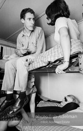 Andy Warhol with unidentified guests horsing around on the bunk beds at a dinner party. New York City, 1965.