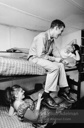 Andy Warhol with unidentified guests horsing around on the bunk beds at a dinner party. New York City, 1965.