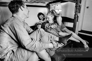 Andy Warhol with unidentified guests horsing around on the bunk beds at a dinner party. New York City, 1965.