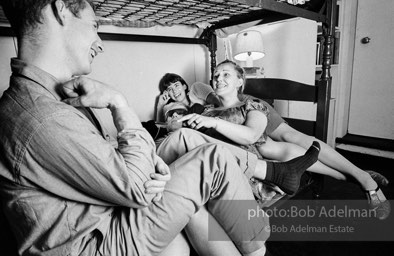 Andy Warhol with unidentified guests horsing around on the bunk beds at a dinner party. New York City, 1965.