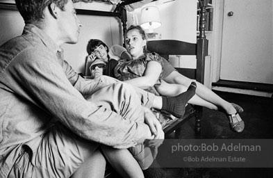 Andy Warhol with unidentified guests horsing around on the bunk beds at a dinner party. New York City, 1965.