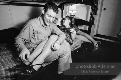 Andy Warhol with unidentified guests horsing around on the bunk beds at a dinner party. New York City, 1965.