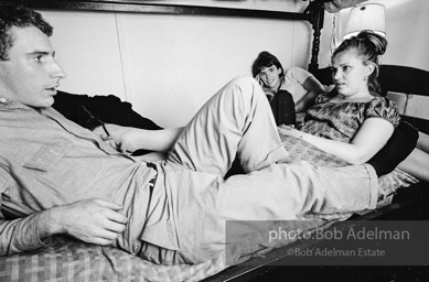 Andy Warhol with unidentified guests horsing around on the bunk beds at a dinner party. New York City, 1965.