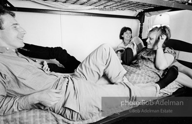 Andy Warhol with unidentified guests horsing around on the bunk beds at a dinner party. New York City, 1965.