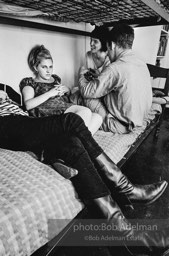 Andy Warhol with unidentified guests horsing around on the bunk beds at a dinner party. New York City, 1965.