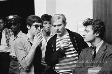 Andy Warhol and Gerard Melanga with unidentified guests at a party. New York City, 1965.