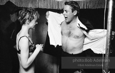 Movie star, Kevin McCarthy strips for Edie Sedgwick, and they join Chuck Wein and Andy in the pool at Al Roon's gym, New York City, 1965.