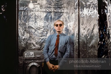 Andy Warhol in the silver foil covered bathroom at the Factory, 1965.