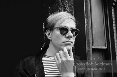 Andy Warhol on the Factory fire escape ouside of the Factory overlooking East 47th St. New York City, 1965.