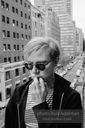 Andy Warhol on the Factory fire escape ouside of the Factory overlooking East 47th St. New York City, 1965.