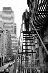 Andy Warhol on the Factory fire escape ouside of the Factory overlooking East 47th St. New York City, 1965.