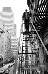 Andy Warhol on the Factory fire escape ouside of the Factory overlooking East 47th St. New York City, 1965.