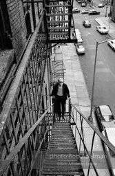 Andy Warhol on the Factory fire escape ouside of the Factory overlooking East 47th St. New York City, 1965.