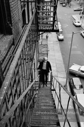 Andy Warhol on the Factory fire escape ouside of the Factory overlooking East 47th St. New York City, 1965.