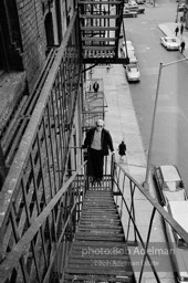 Andy Warhol on the Factory fire escape ouside of the Factory overlooking East 47th St. New York City, 1965.