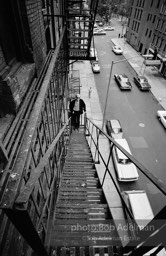 Andy Warhol on the Factory fire escape ouside of the Factory overlooking East 47th St. New York City, 1965.