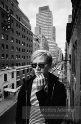 Andy Warhol on the Factory fire escape ouside of the Factory overlooking East 47th St. New York City, 1965.