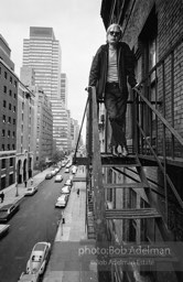 Andy Warhol on the Factory fire escape ouside of the Factory overlooking East 47th St. New York City, 1965.