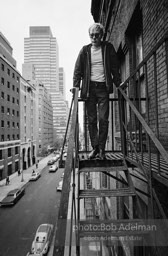 Andy Warhol on the Factory fire escape ouside of the Factory overlooking East 47th St. New York City, 1965.