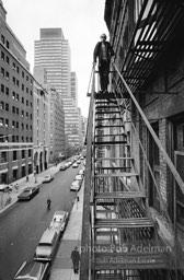 Andy Warhol on the Factory fire escape ouside of the Factory overlooking East 47th St. New York City, 1965.