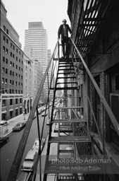 Andy Warhol on the Factory fire escape ouside of the Factory overlooking East 47th St. New York City, 1965.