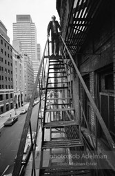 Andy Warhol on the Factory fire escape ouside of the Factory overlooking East 47th St. New York City, 1965.